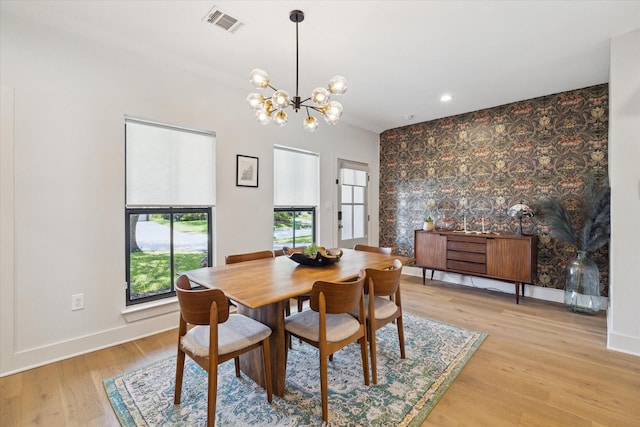 1810 Nauts Ct, Houston, TX 77008 - dining room with a chandelier, light wood finished floors, an accent wall, and recessed lighting
