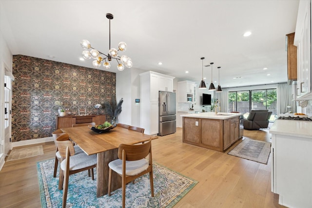 1810 Nauts Ct, Houston, TX 77008 - dining space featuring an accent wall, a chandelier, light wood finished floors, wallpapered walls, and recessed lighting
