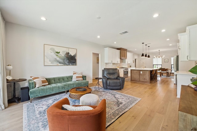 1810 Nauts Ct, Houston, TX 77008 - living room with light wood-style flooring, recessed lighting, and a chandelier