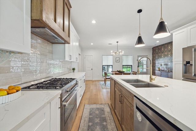 1810 Nauts Ct, Houston, TX 77008 - kitchen featuring stainless steel appliances, custom exhaust hood, light wood-type flooring, white cabinets, and light stone counters