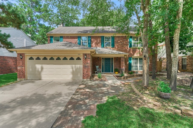 100 W Rainbow Ridge Cir, The Woodlands, TX 77381 - view of front of home with an attached garage, brick siding, concrete driveway, a chimney, and roof with shingles