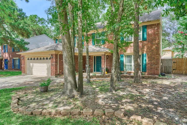100 W Rainbow Ridge Cir, The Woodlands, TX 77381 - view of front facade with an attached garage, covered porch, brick siding, driveway, and a shingled roof