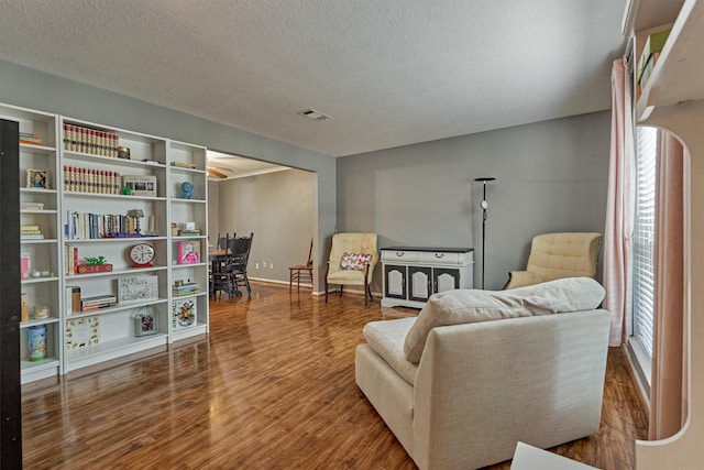 100 W Rainbow Ridge Cir, The Woodlands, TX 77381 - sitting room featuring healthy amount of natural light, wood finished floors, and a textured ceiling