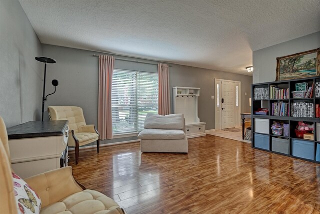 100 W Rainbow Ridge Cir, The Woodlands, TX 77381 - sitting room with wood finished floors and a textured ceiling