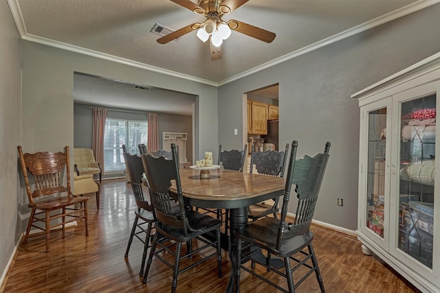 100 W Rainbow Ridge Cir, The Woodlands, TX 77381 - dining space with dark wood-style flooring, a ceiling fan, a textured ceiling, french doors, and ornamental molding
