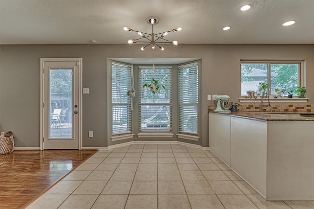 100 W Rainbow Ridge Cir, The Woodlands, TX 77381 - doorway with healthy amount of natural light, recessed lighting, and a chandelier