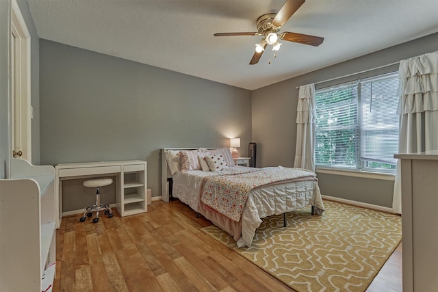 100 W Rainbow Ridge Cir, The Woodlands, TX 77381 - bedroom with wood finished floors and ceiling fan