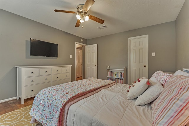 100 W Rainbow Ridge Cir, The Woodlands, TX 77381 - bedroom with wood finished floors and ceiling fan