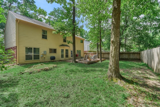100 W Rainbow Ridge Cir, The Woodlands, TX 77381 - back of house featuring a fenced backyard and a deck