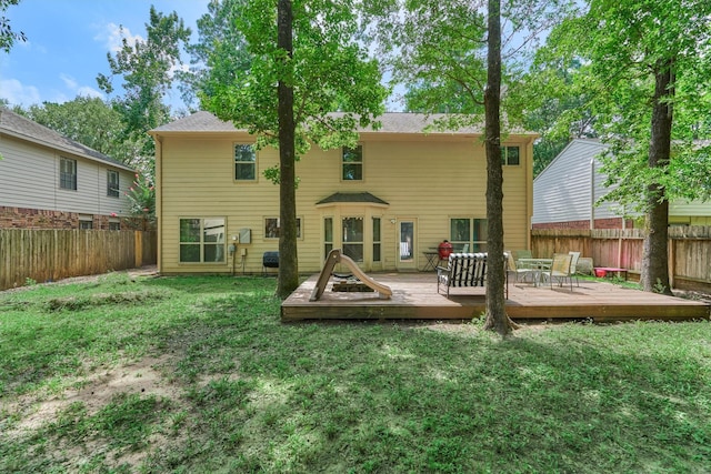 100 W Rainbow Ridge Cir, The Woodlands, TX 77381 - rear view of property featuring a fenced backyard and a wooden deck