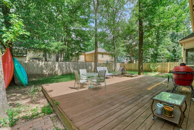 100 W Rainbow Ridge Cir, The Woodlands, TX 77381 - wooden deck with outdoor dining area and a fenced backyard