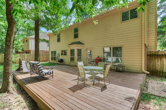100 W Rainbow Ridge Cir, The Woodlands, TX 77381 - wooden terrace featuring a fenced backyard and outdoor dining space
