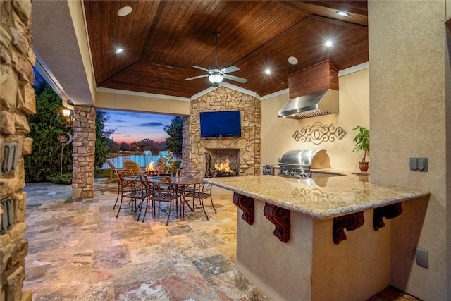 102 Lake Sterling Gate Dr, Spring, TX 77379 - view of patio with an outdoor stone fireplace, exterior kitchen, outdoor dining space, and ceiling fan