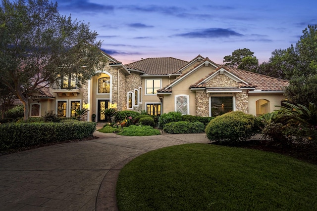 102 Lake Sterling Gate Dr, Spring, TX 77379 - view of front of house featuring stone siding, stucco siding, a lawn, and a tiled roof