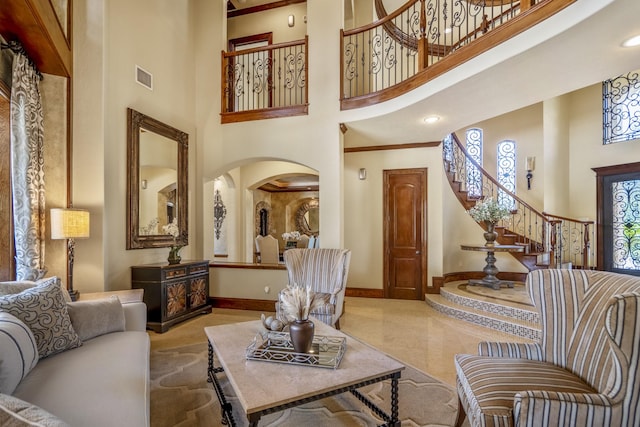 102 Lake Sterling Gate Dr, Spring, TX 77379 - living room with a towering ceiling, arched walkways, and stairs