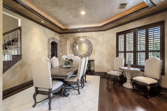 102 Lake Sterling Gate Dr, Spring, TX 77379 - dining area with a raised ceiling, crown molding, wood finished floors, a textured wall, and recessed lighting