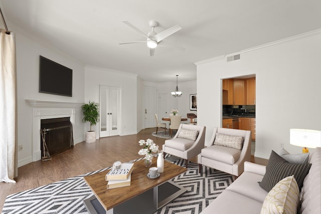 5200 Weslayan St Unit 101, Houston, TX 77005 - living area featuring wood finished floors, a ceiling fan, ornamental molding, a chandelier, and a fireplace