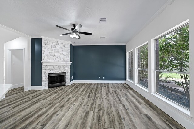 1826 Cheyenne River Cir, Sugar Land, TX 77478 - unfurnished living room with wood finished floors, a ceiling fan, crown molding, a fireplace, and a textured ceiling