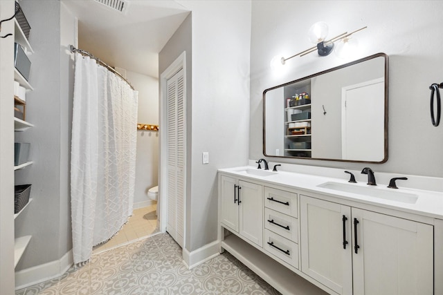 4914 Feagan St, Houston, TX 77007 - bathroom featuring double vanity, tile patterned floors, a shower with curtain, and a closet
