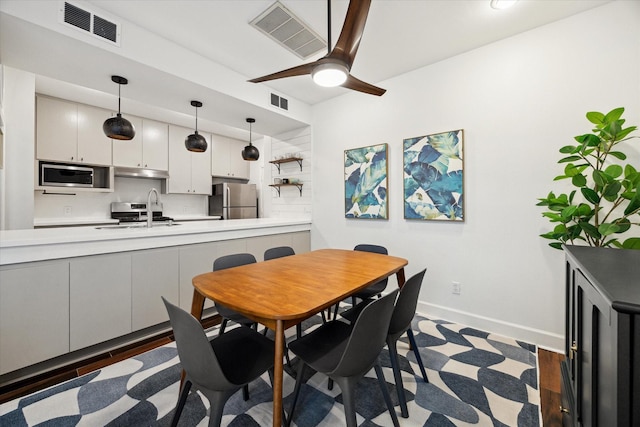 4914 Feagan St, Houston, TX 77007 - dining space featuring baseboards and a ceiling fan