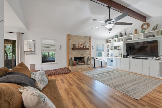 600 Erin Cir, Leander, TX 78641 - living area with wood finished floors, healthy amount of natural light, a stone fireplace, and a ceiling fan