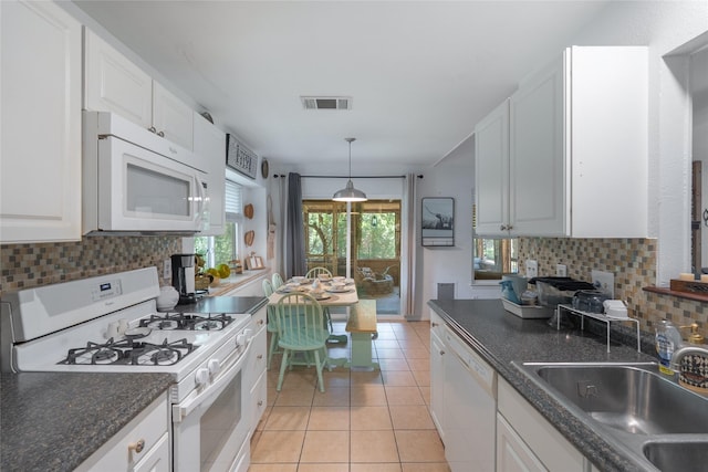 600 Erin Cir, Leander, TX 78641 - kitchen featuring white appliances, decorative backsplash, white cabinetry, and light tile patterned flooring