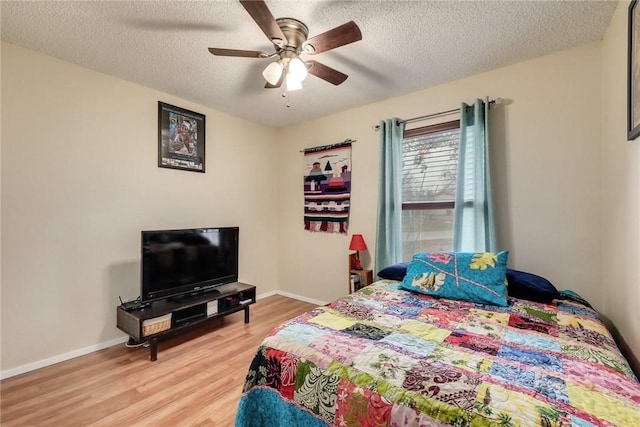 600 Erin Cir, Leander, TX 78641 - bedroom featuring light wood-type flooring, a textured ceiling, and a ceiling fan