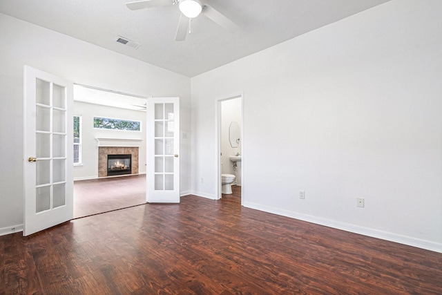 3242 Enchanted Hollow Ln, Spring, TX 77388 - unfurnished living room featuring french doors, wood finished floors, a ceiling fan, and a fireplace