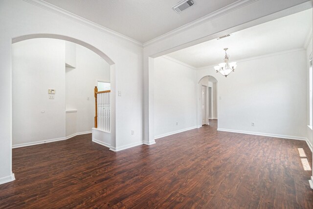 3242 Enchanted Hollow Ln, Spring, TX 77388 - empty room featuring arched walkways, dark wood finished floors, a chandelier, and crown molding