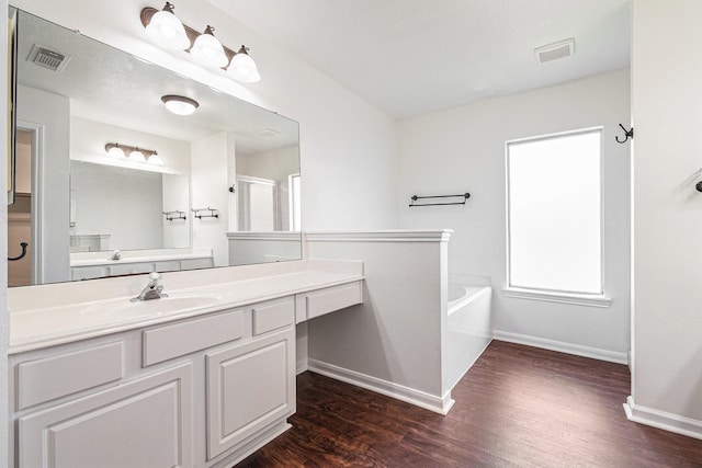 3242 Enchanted Hollow Ln, Spring, TX 77388 - bathroom featuring a bath, wood finished floors, and vanity