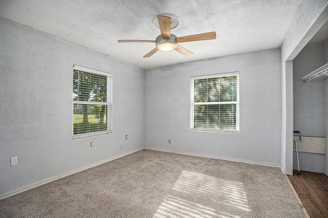 4028 N 1/2 Ave, Santa Fe, TX 77510 - unfurnished bedroom with multiple windows, a ceiling fan, a textured ceiling, and carpet floors