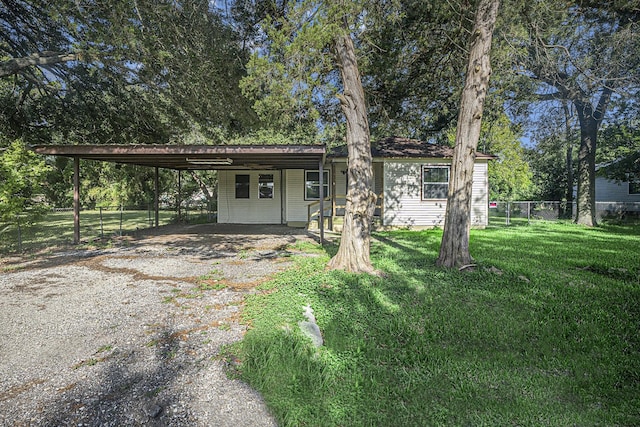 4028 N 1/2 Ave, Santa Fe, TX 77510 - view of front facade with gravel driveway and a carport