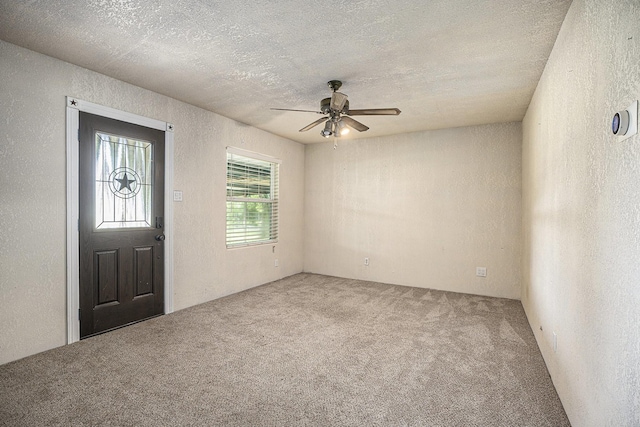4028 N 1/2 Ave, Santa Fe, TX 77510 - entrance foyer featuring a textured wall, carpet, ceiling fan, and a textured ceiling