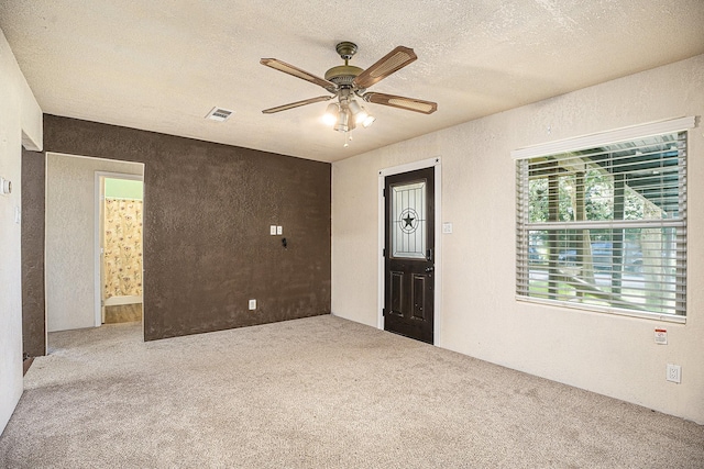 4028 N 1/2 Ave, Santa Fe, TX 77510 - unfurnished room with carpet, a ceiling fan, a textured wall, and a textured ceiling
