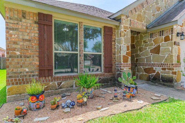 2010 Wembley Way, Rosenberg, TX 77471 - property entrance featuring stone siding, brick siding, and a shingled roof