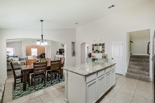 2010 Wembley Way, Rosenberg, TX 77471 - kitchen with arched walkways, vaulted ceiling, a kitchen island, pendant lighting, and light tile patterned flooring
