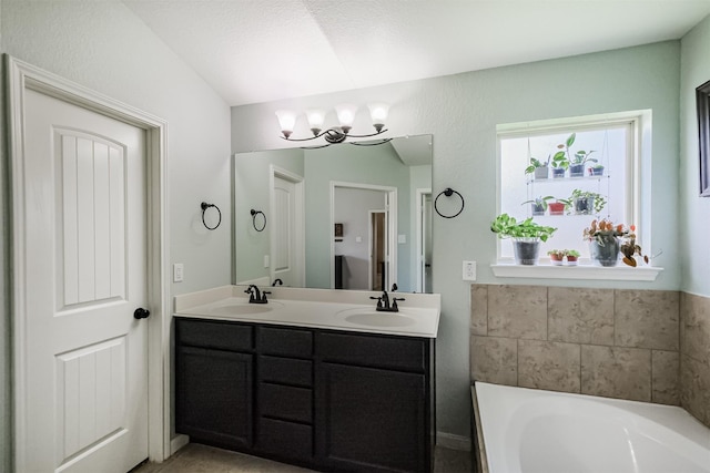 2010 Wembley Way, Rosenberg, TX 77471 - full bathroom with a bath, double vanity, and a chandelier
