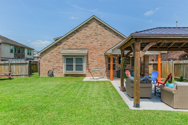 2010 Wembley Way, Rosenberg, TX 77471 - back of house featuring brick siding, a patio, and a fenced backyard