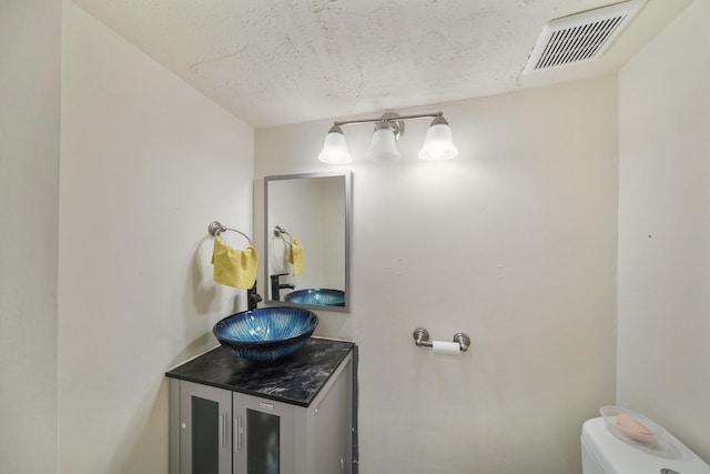 4723 Aftonshire Dr Unit 15, Houston, TX 77027 - bathroom with vanity and a textured ceiling