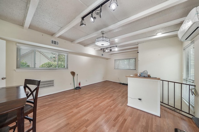 4723 Aftonshire Dr Unit 15, Houston, TX 77027 - unfurnished office with a wall mounted air conditioner, beam ceiling, rail lighting, and light wood-style flooring