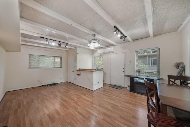 4723 Aftonshire Dr Unit 15, Houston, TX 77027 - living area with beamed ceiling, light wood-style flooring, and a wall mounted AC