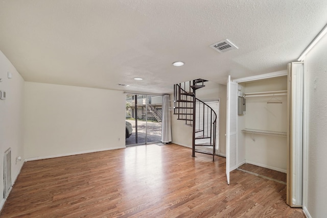 4723 Aftonshire Dr Unit 15, Houston, TX 77027 - empty room with stairway, wood finished floors, recessed lighting, and a textured ceiling