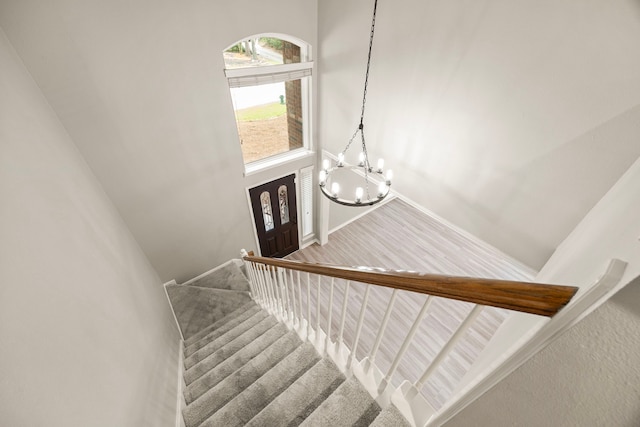 22 Windfern Pl, The Woodlands, TX 77382 - stairway with a chandelier