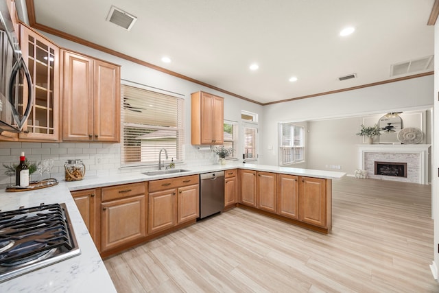 22 Windfern Pl, The Woodlands, TX 77382 - kitchen with stainless steel appliances, ornamental molding, tasteful backsplash, a peninsula, and recessed lighting