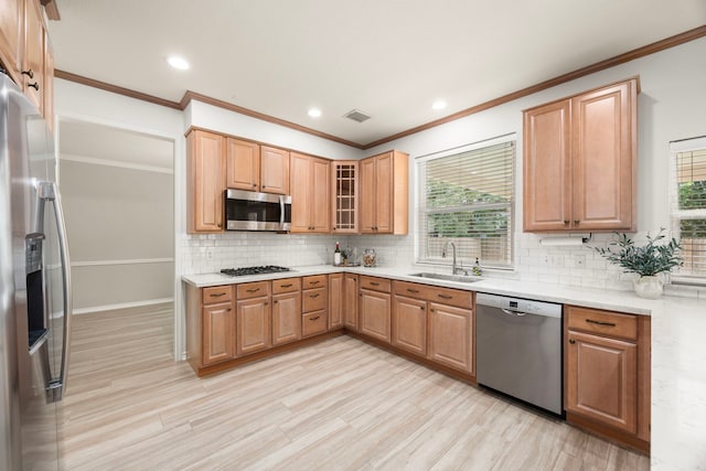 22 Windfern Pl, The Woodlands, TX 77382 - kitchen with stainless steel appliances, healthy amount of natural light, tasteful backsplash, ornamental molding, and glass insert cabinets