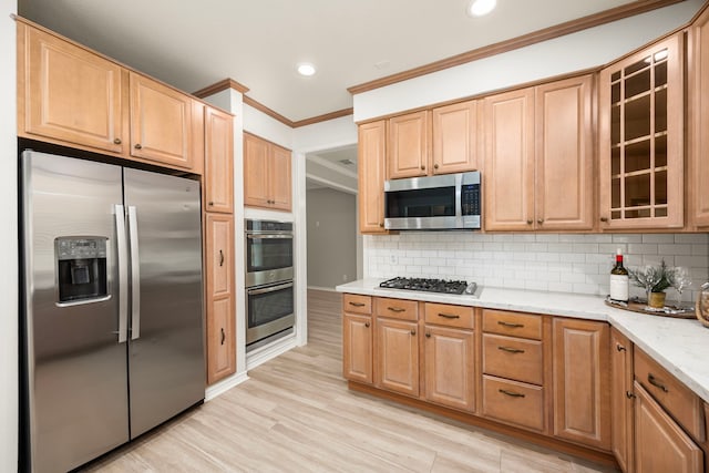 22 Windfern Pl, The Woodlands, TX 77382 - kitchen featuring appliances with stainless steel finishes, crown molding, light stone countertops, glass insert cabinets, and tasteful backsplash