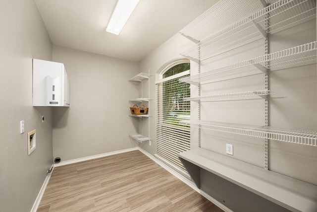 22 Windfern Pl, The Woodlands, TX 77382 - laundry area with hookup for an electric dryer, light wood finished floors, and washer hookup