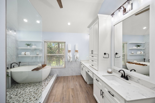 22 Windfern Pl, The Woodlands, TX 77382 - bathroom with tile walls, vanity, a freestanding bath, wood finished floors, and recessed lighting
