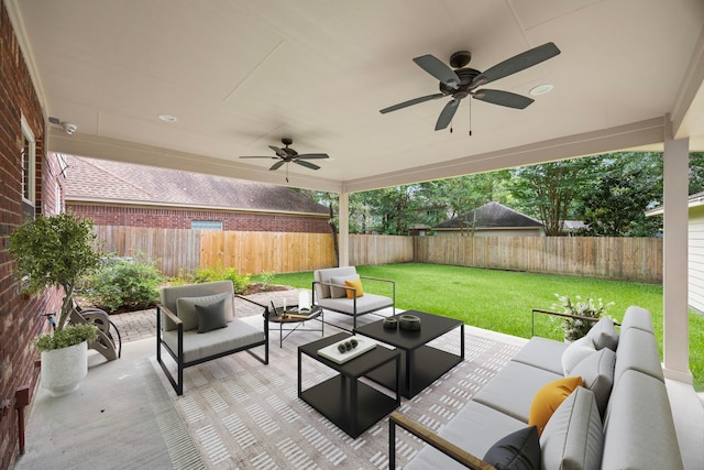 22 Windfern Pl, The Woodlands, TX 77382 - fenced backyard with an outdoor living space, a ceiling fan, and a patio area