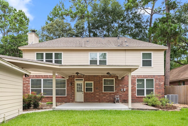 22 Windfern Pl, The Woodlands, TX 77382 - back of house featuring ceiling fan, brick siding, a chimney, and a patio
